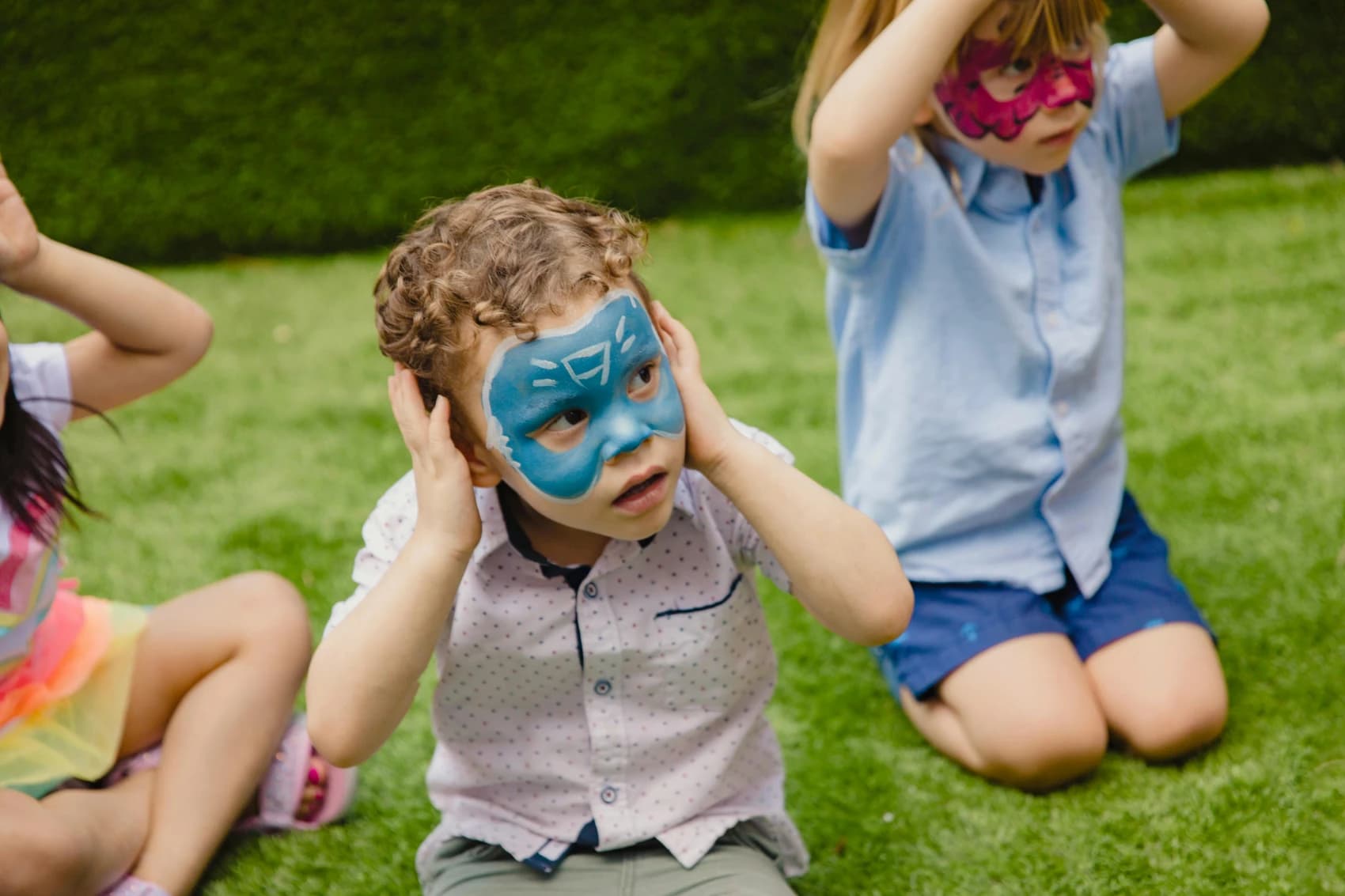 A picture of young children with face paint at a community fair.
