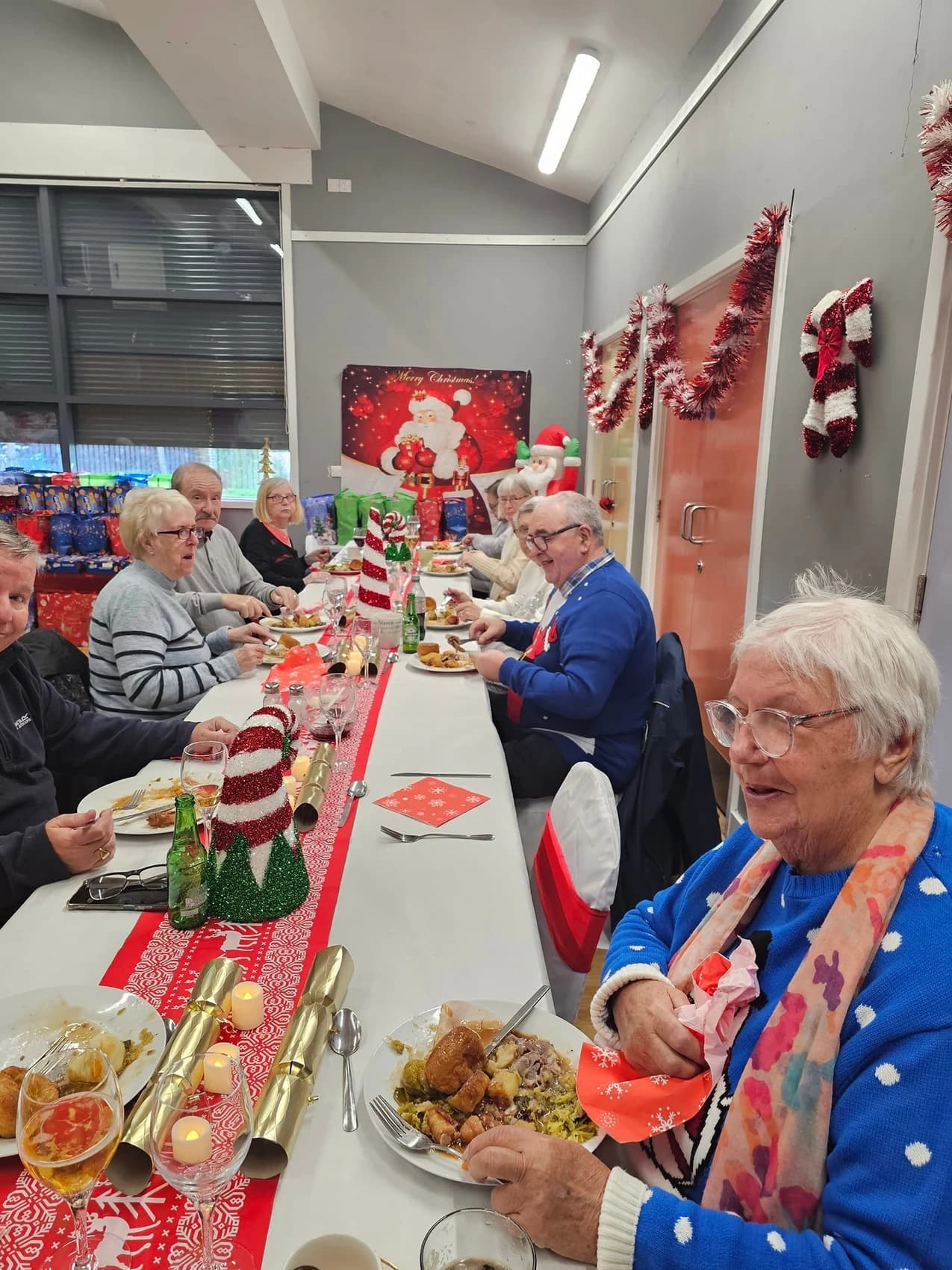 A picture of a group of elderly people enjoying a celebratory lunch hosted at the Hillside Neighbourhood centre.