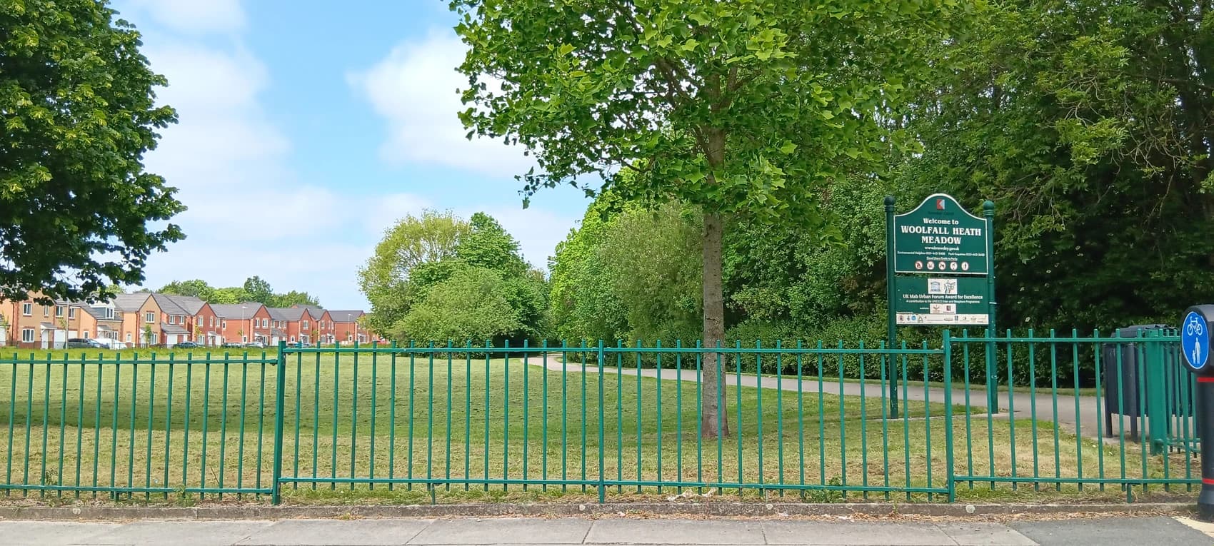 A picture of Woolfall Health Meadow in front of newly built NHCF housing.